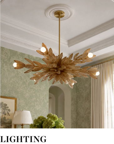 Chandelier with leaf design hanging from a ceiling in a softly lit room.