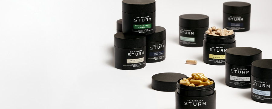 Various black jars of supplements on a white background.