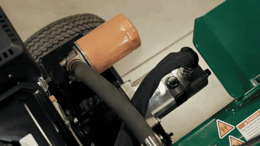 Close-up of machinery components, including a tire and hoses.