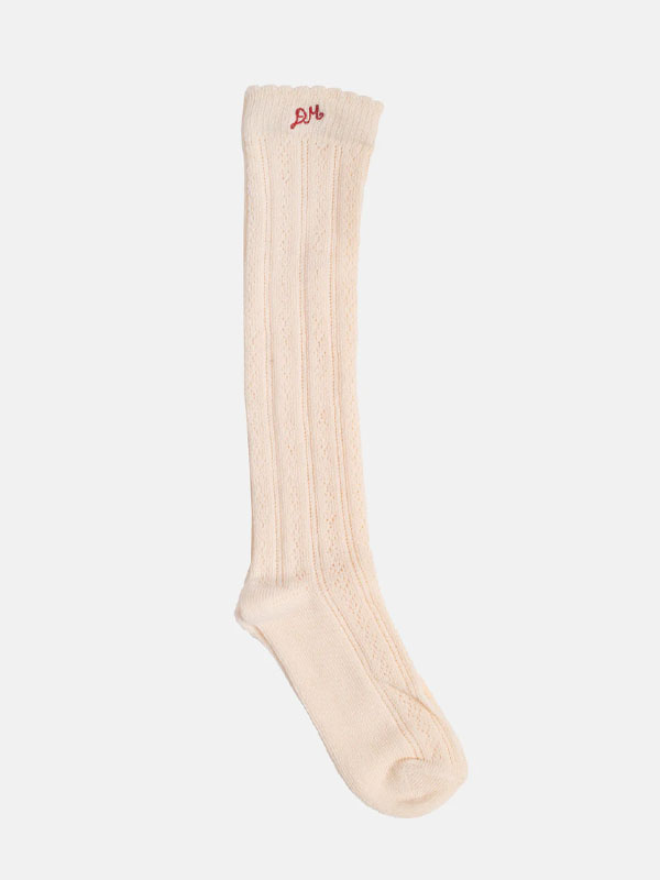 Knee-high, cream-colored sock with ribbed texture and red logo at the top.
