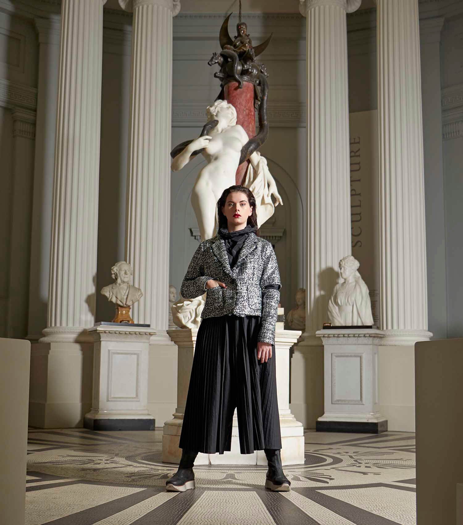 A women is stood in the middle of the 18th century room at the Lady Lever Art Gallery.  Famous sculpture 'Salammbo' is behind her.