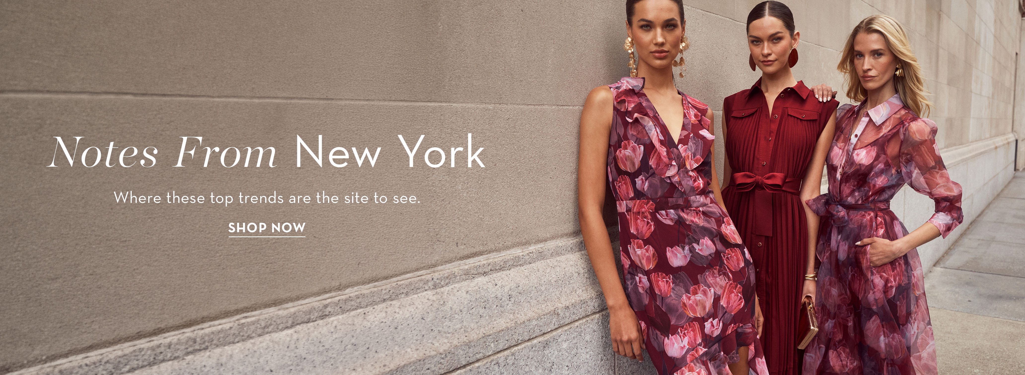Three women in stylish dresses posing, with 