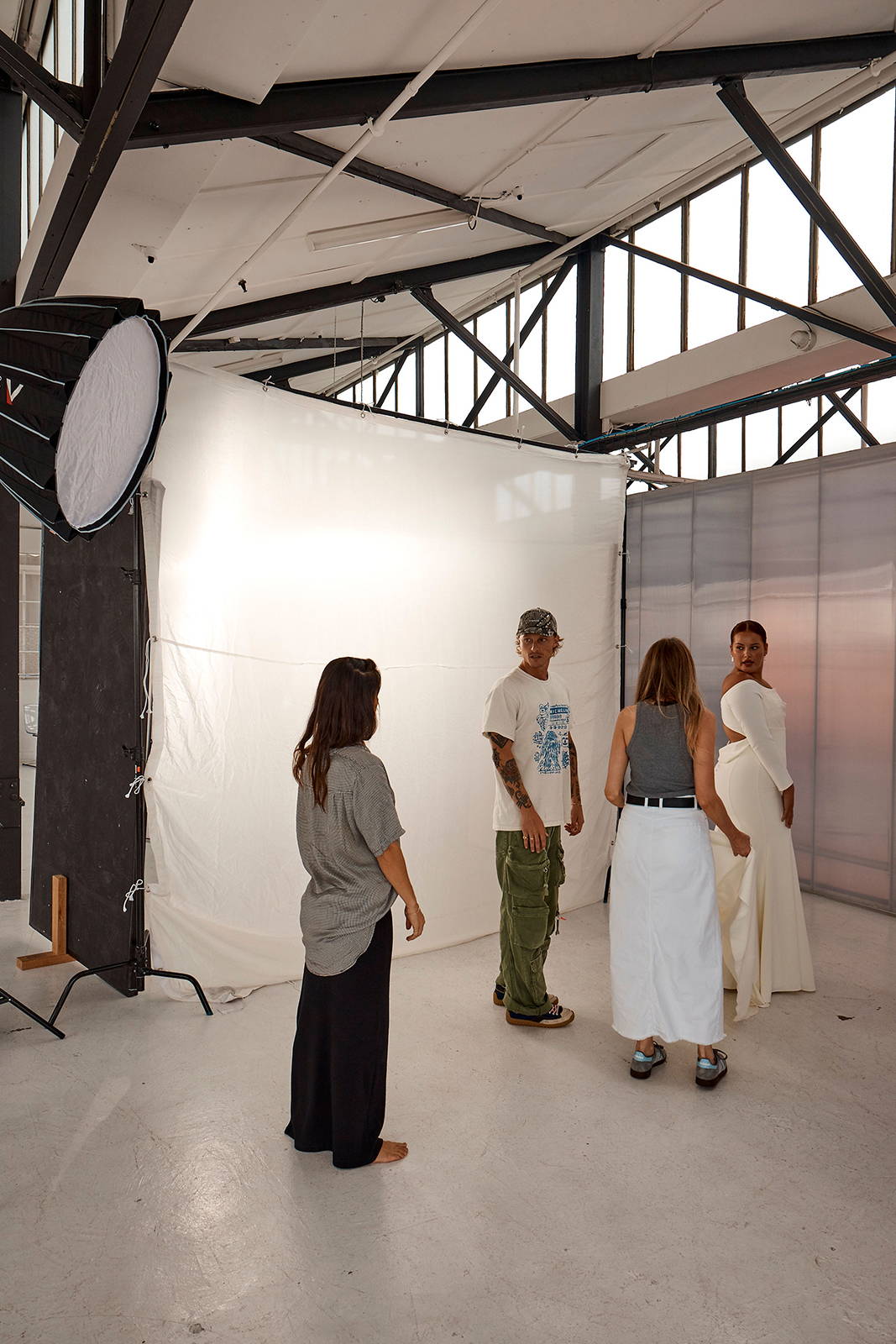Behind the scenes image on-set shooting model in Deia, with stylists directing shoot