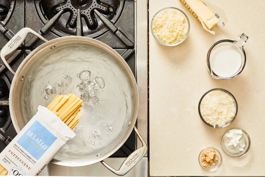 Fettuccine pasta being added to boiling water