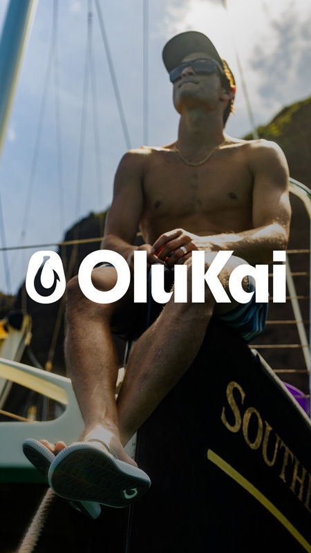 A shirtless person sitting on a boat with sunglasses.