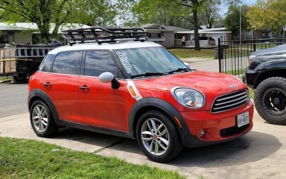 Front three-quarter red 2011 Mini Cooper Countryman white roof basket roof rack Tina's Conductor's Special 2HB train horn kit featured customer install gallery photo 1