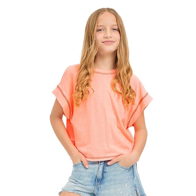 Girl with long hair wearing a pink shirt and denim shorts.