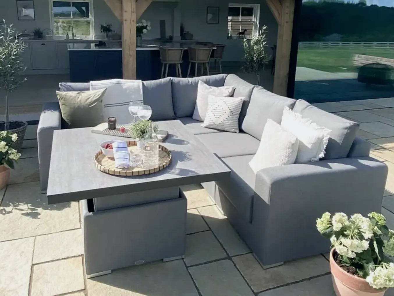 Outdoor modular sofa made from outdoor fabrics with adjustable table.