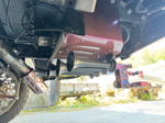 Close-up of train horn kit with compressor and air lines mounted under Ram 1500 chassis