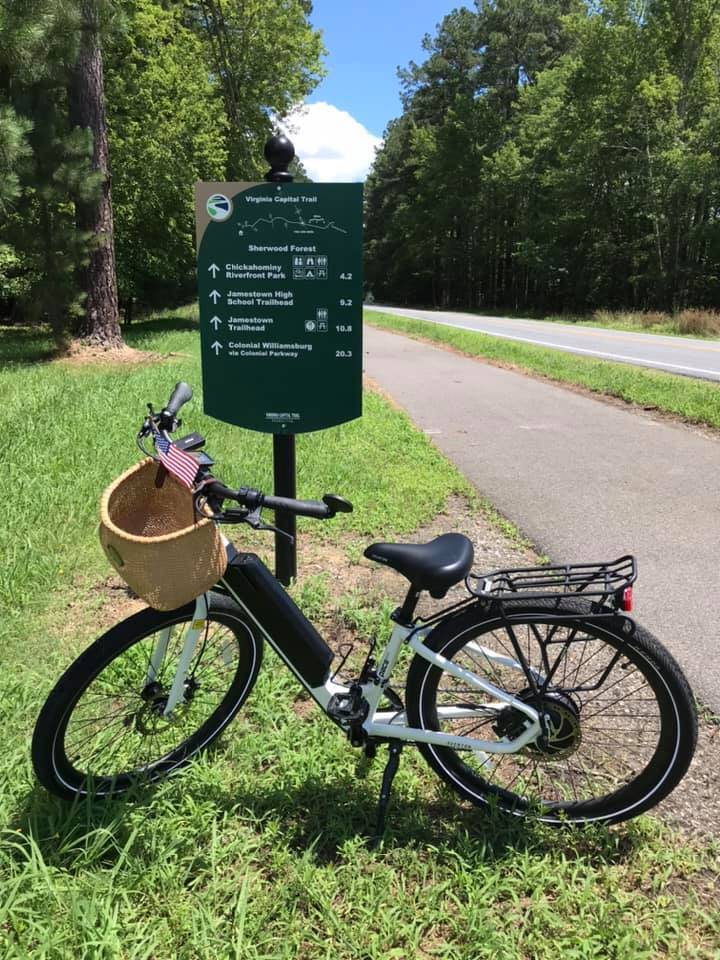 White Pace 350 with front basket and a flag as decoration.