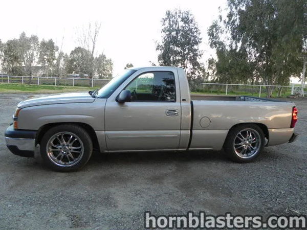 Side profile view of Thomas's silver 2005 Chevrolet Silverado 1500 single cab on chrome wheels, install photo 1