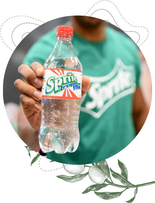 A man holding a 20 oz bottle of Tropical Mix Sprite