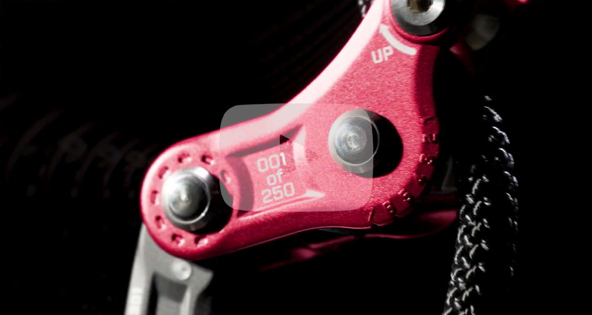 Close-up of a red mechanical component against a dark background.