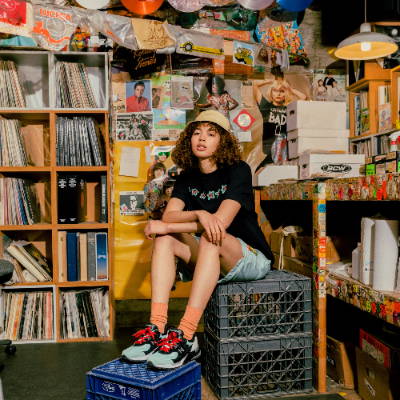 woman wearing all nice kicks x amoeba apparel and shoes in record shop