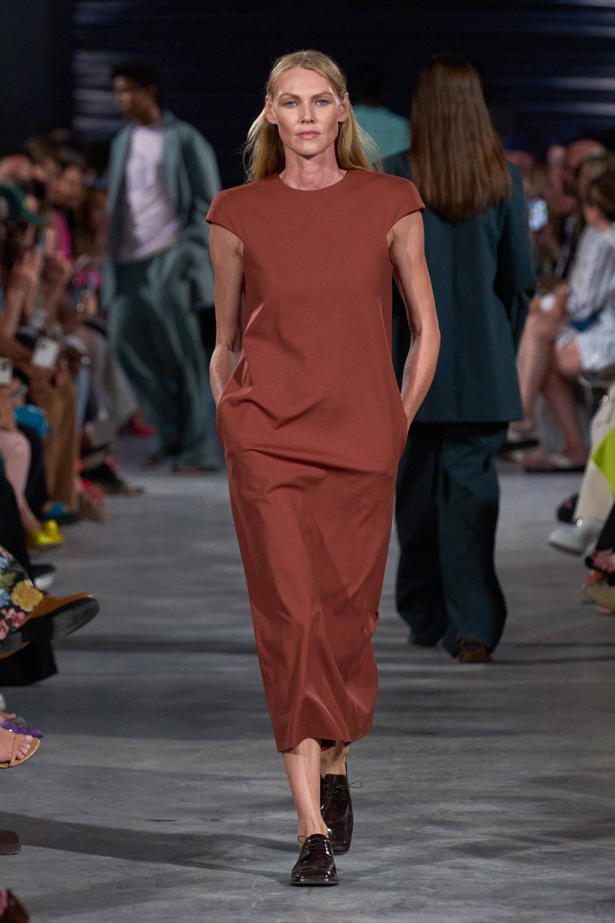 Model on a runway wearing cap sleeve dress