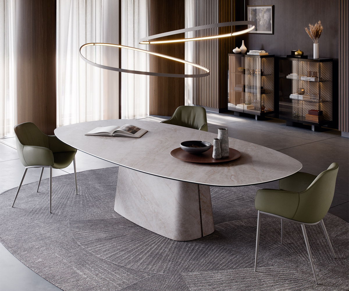 Modern Cattelan Italia dining room with oval table and green chairs under decorative lighting.