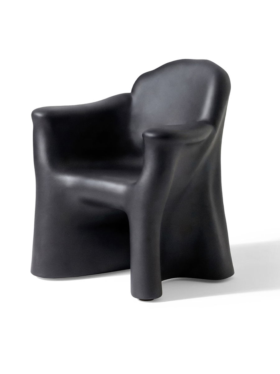 A modern, sculptural black Dalila chair by Gaetano PEsce with rounded edges and a unique design.