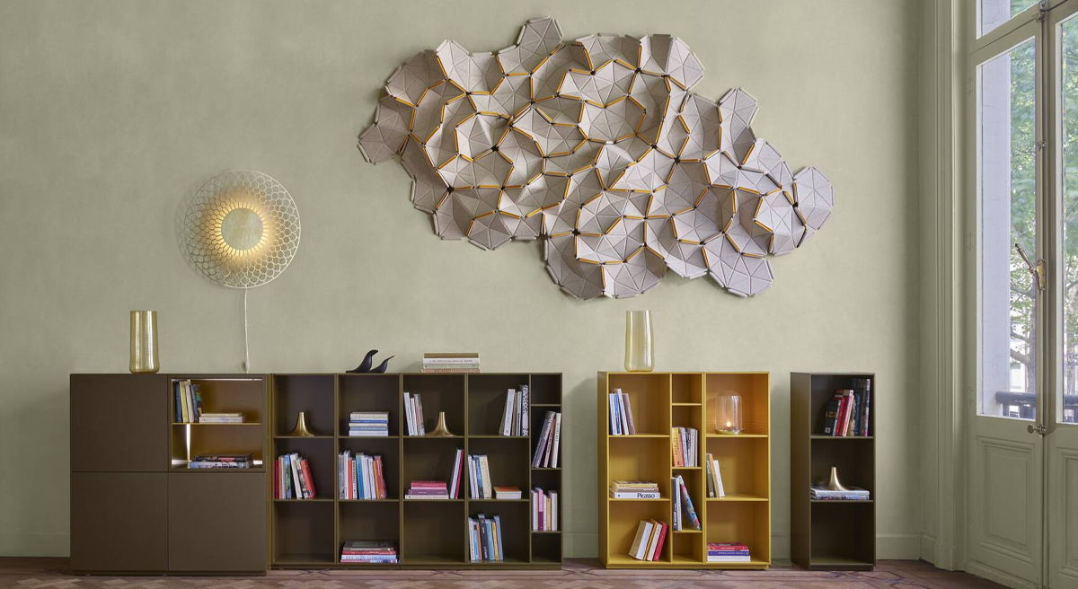 Modern interior with bookshelves and abstract wall art acoustic paneling. Natural light.