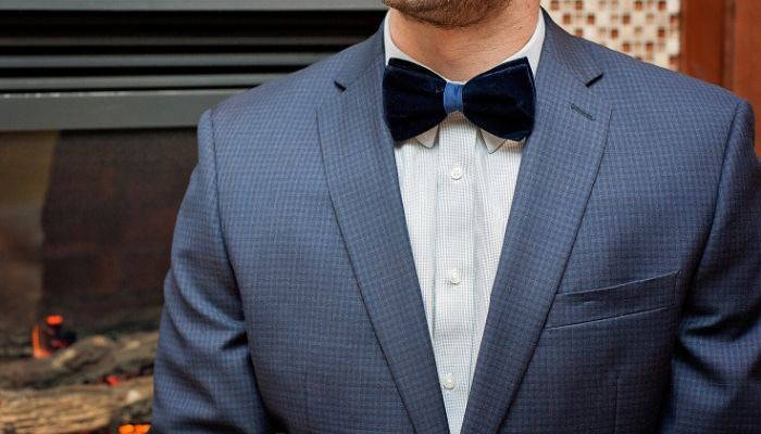 Man wearing blue velvet tie with suit jacket