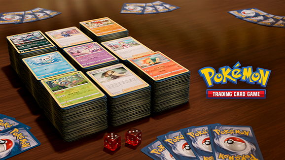 A tabletop scene featuring Pokémon trading cards and dice.
