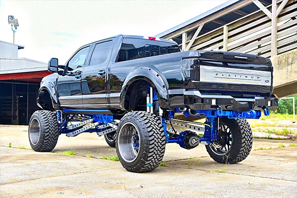 Rear view of Jeff's lifted black 2017 Ford F250 Platinum with blue suspension and custom rear bumper