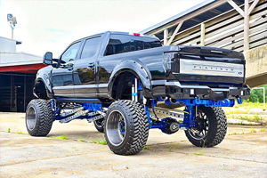 Rear view of Jeff's lifted black 2017 Ford F250 Platinum with blue suspension and custom rear bumper