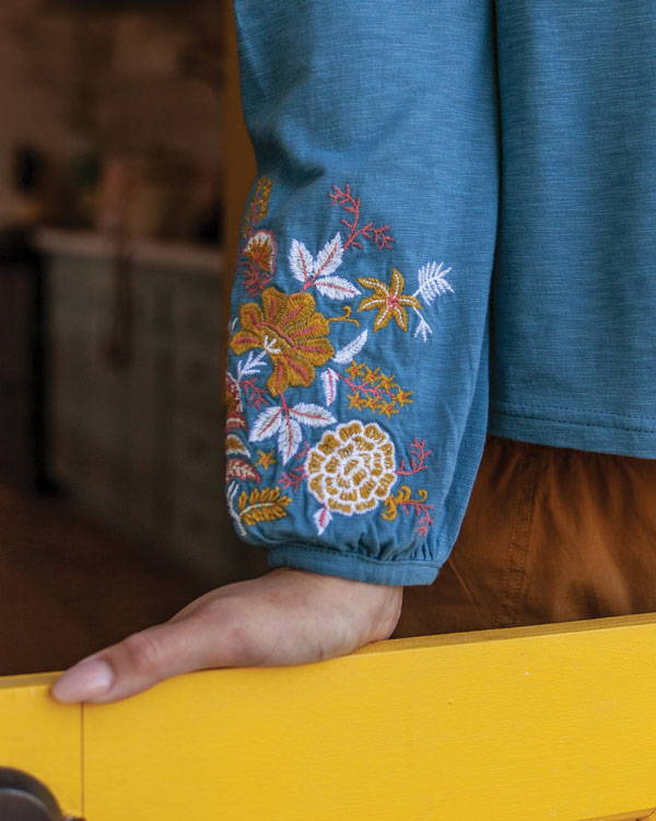 Detail embroidery on sleeve of Kateri shirt.