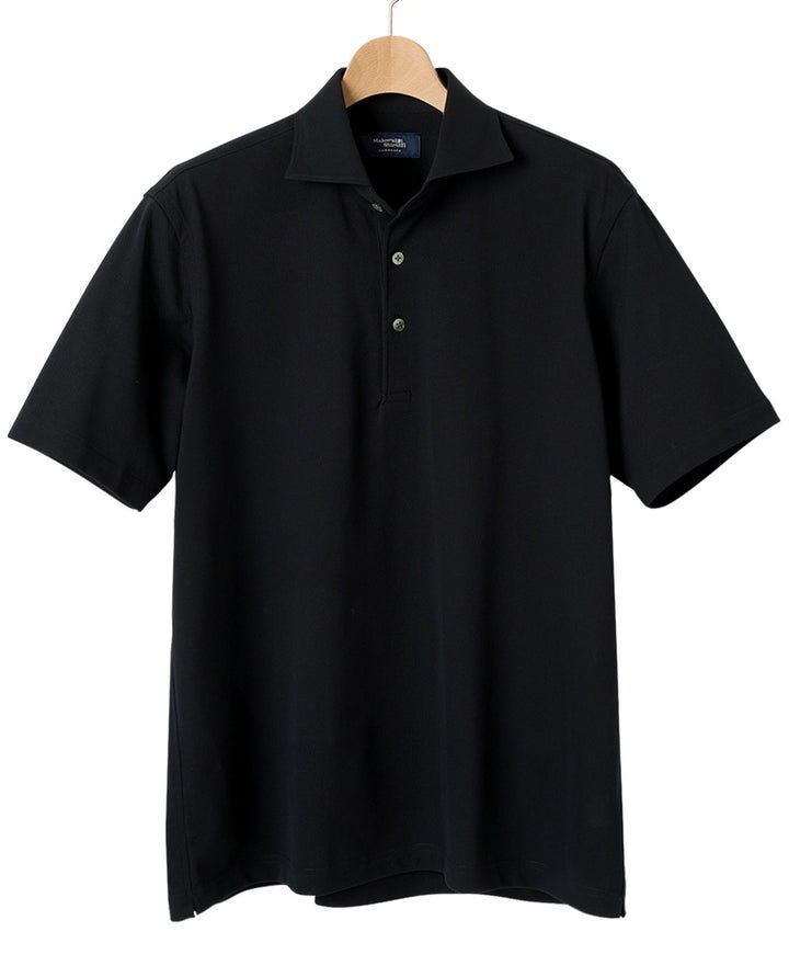 Black polo shirt hanging on a wooden hanger.