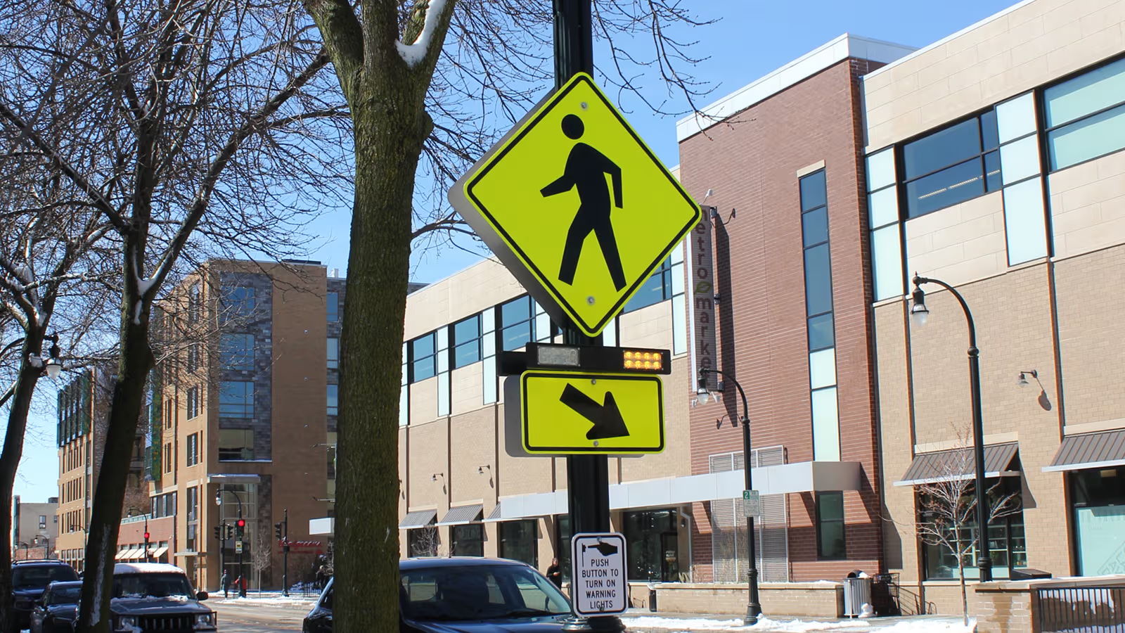 RRFB light bars flashing at a pedestrian crosswalk