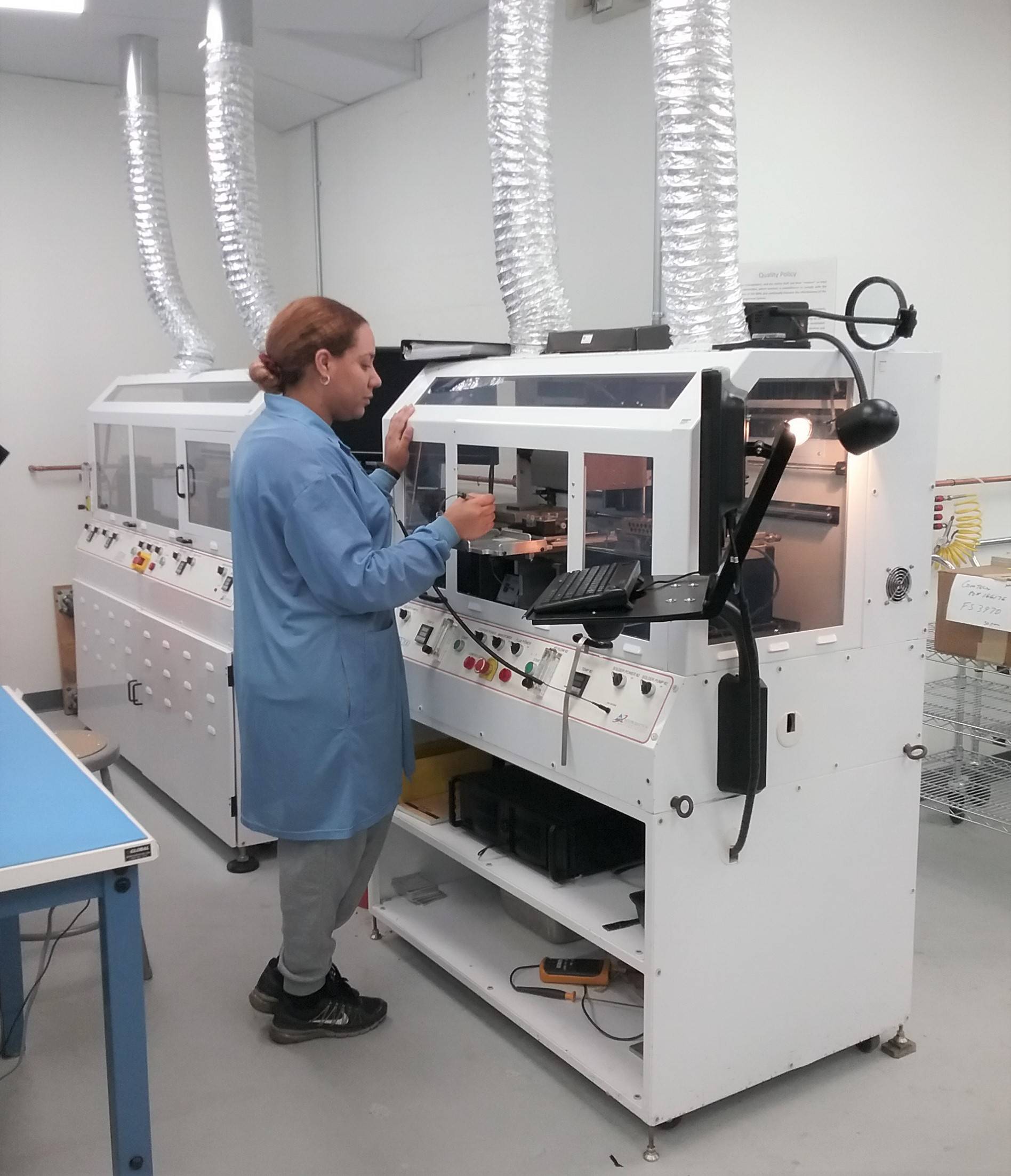 woman observing industrial machine 