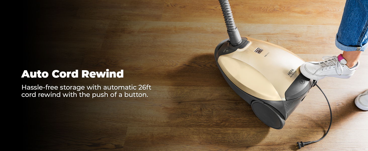 Vacuum cleaner with auto cord rewind feature on wooden floor.