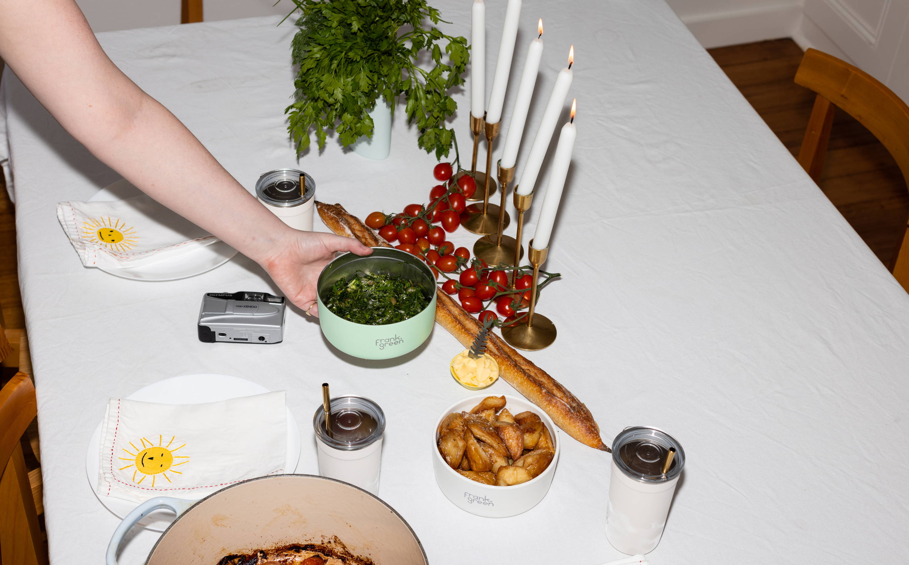 plating the dinner table with food ready to go in stainless steel and porcelain bowls