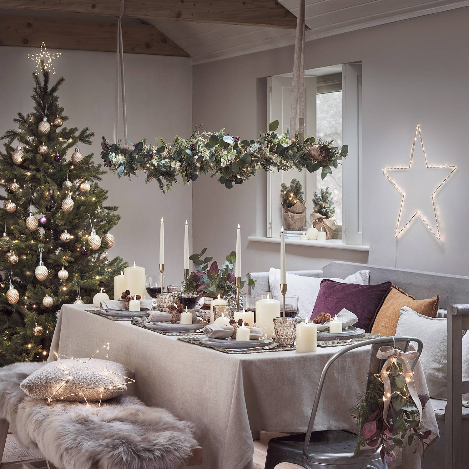 A Christmas dining table set up with a DIY hanging Christmas decoration.
