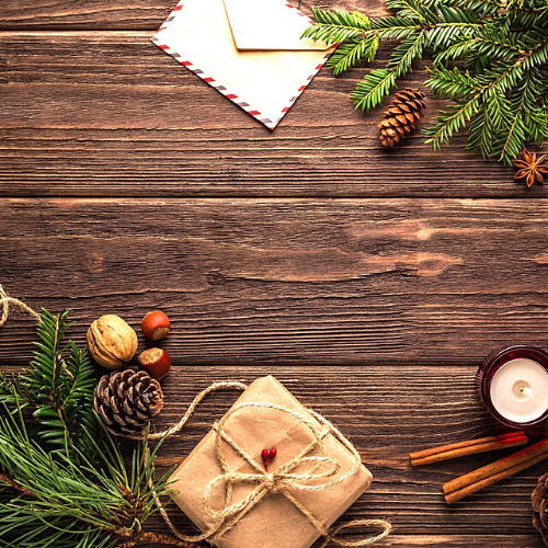 Christmas wreath, red hats on wooden table