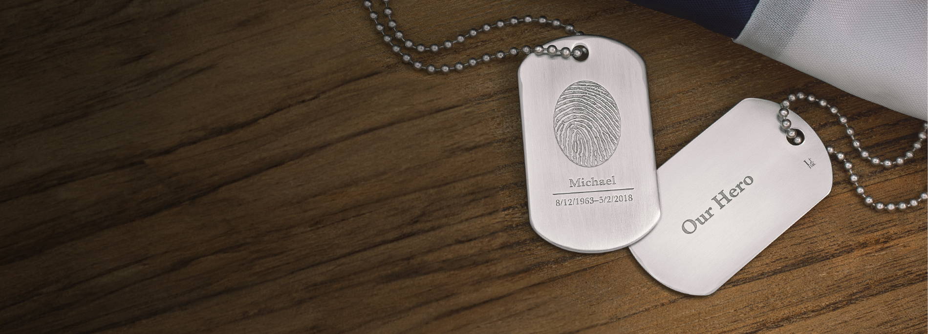 stainless steel military dog tags engraved with a fingerprint, name, and inscription