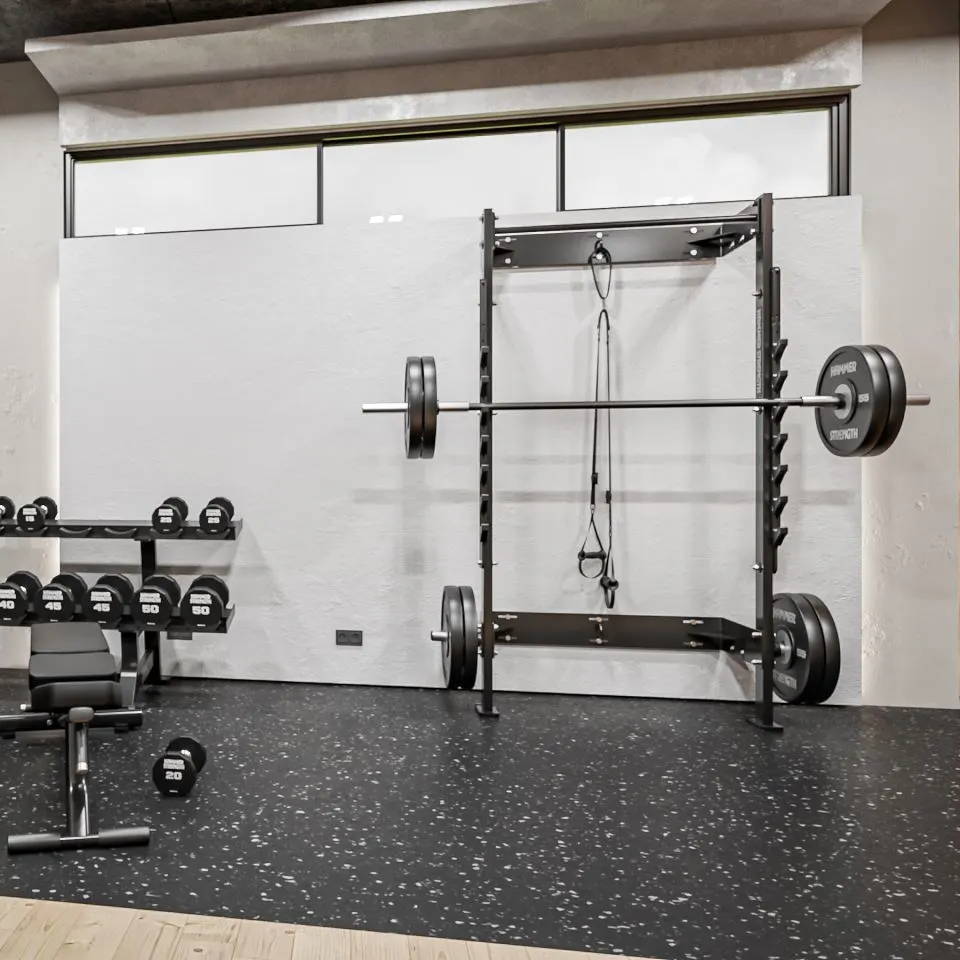 Home gym with Home Squat Rack bolted to the wall and other Hammer Strength equipment