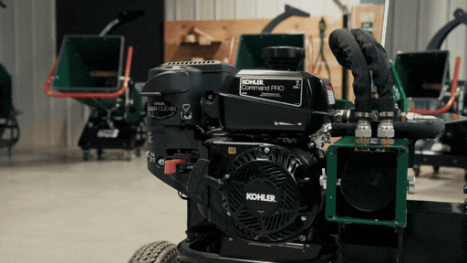 Close-up of a black engine on machinery in a workshop setting.