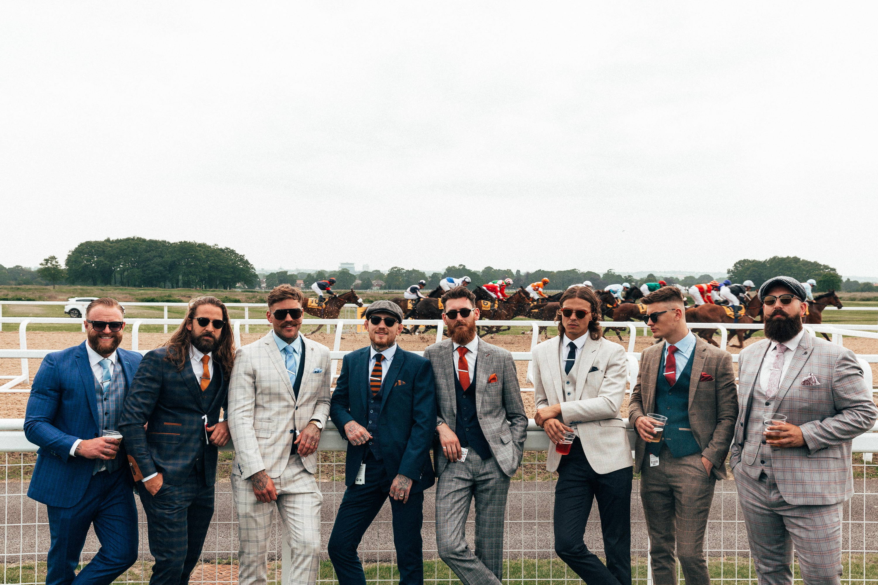men wearing suits at the horse races track