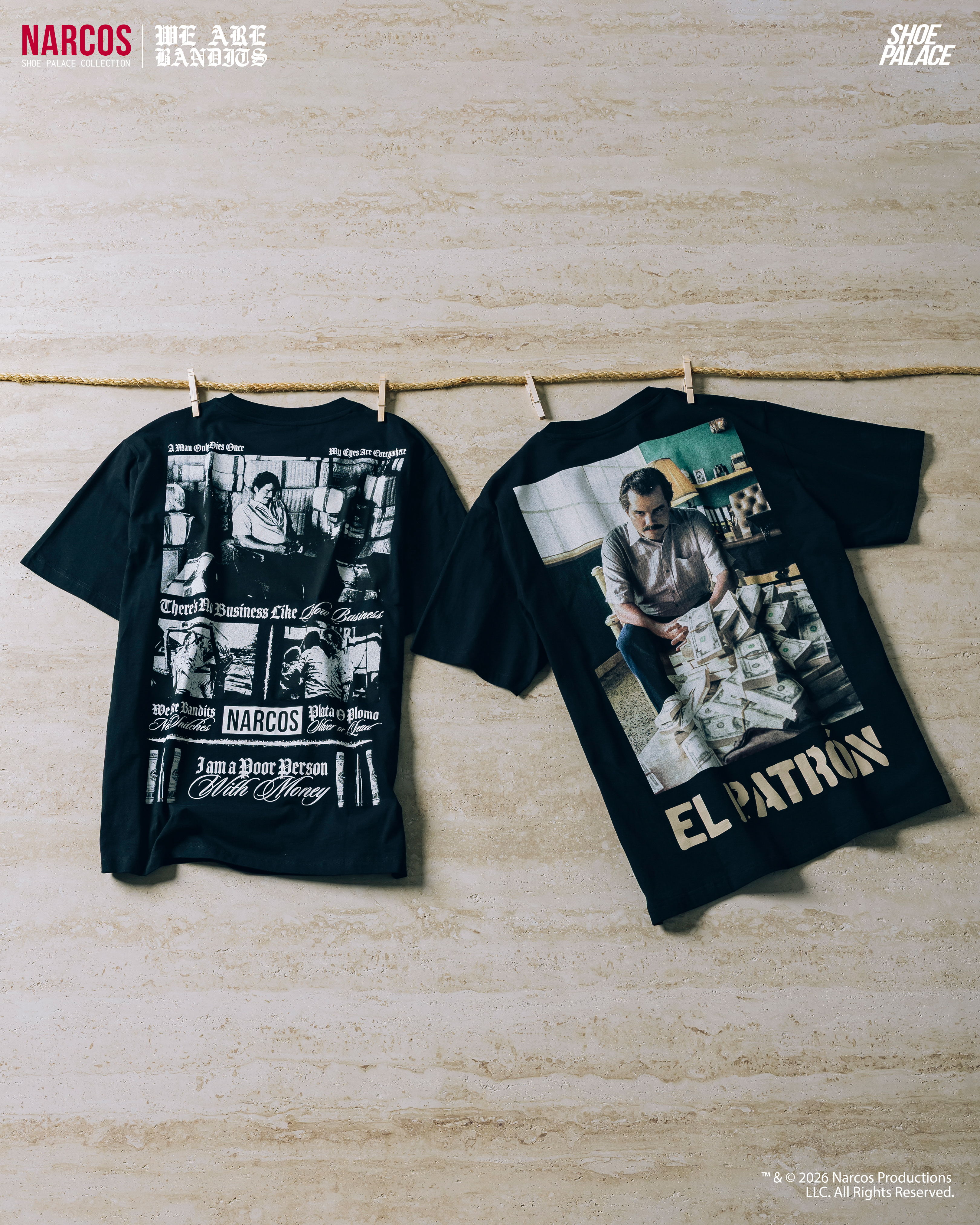 Two black t-shirts hanging, featuring graphic designs and text related to 