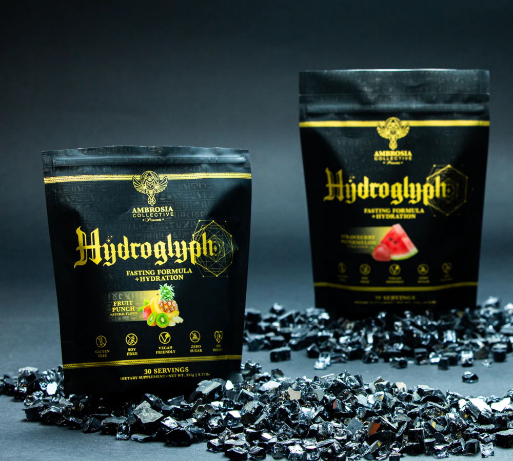 Two bags of Hydroglyph on a dark background with black pieces scattered.
