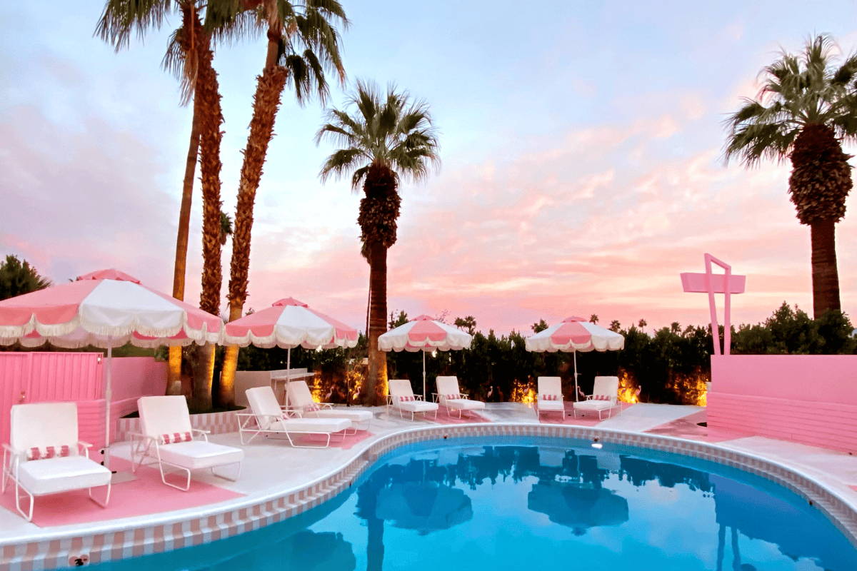 Boxhill's collaboration with the Trixie Motel pool deck in Palm Springs features pink and white umbrellas