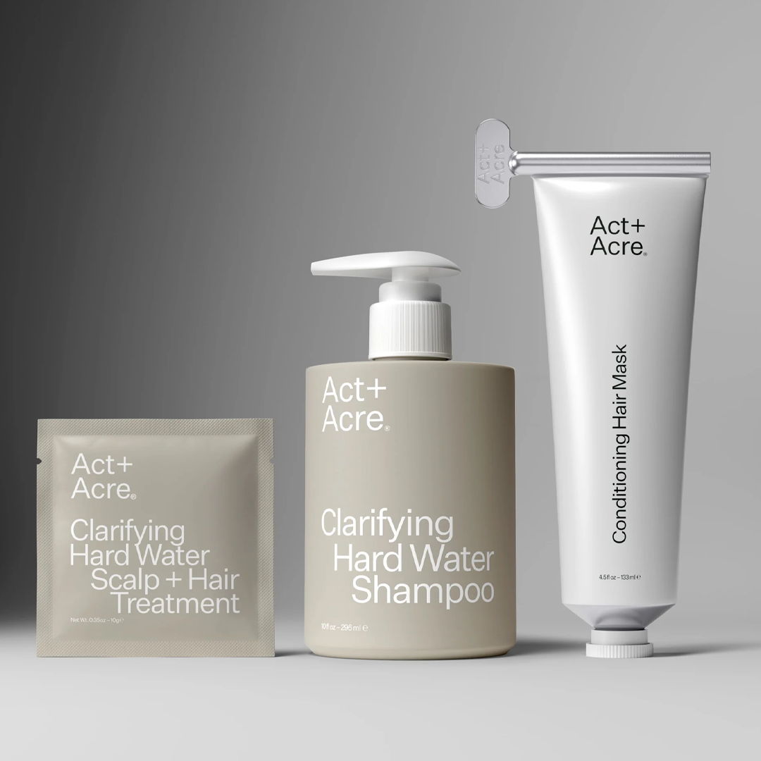 Three hair care products from Act+Acre: shampoo, treatment, and conditioning mask.