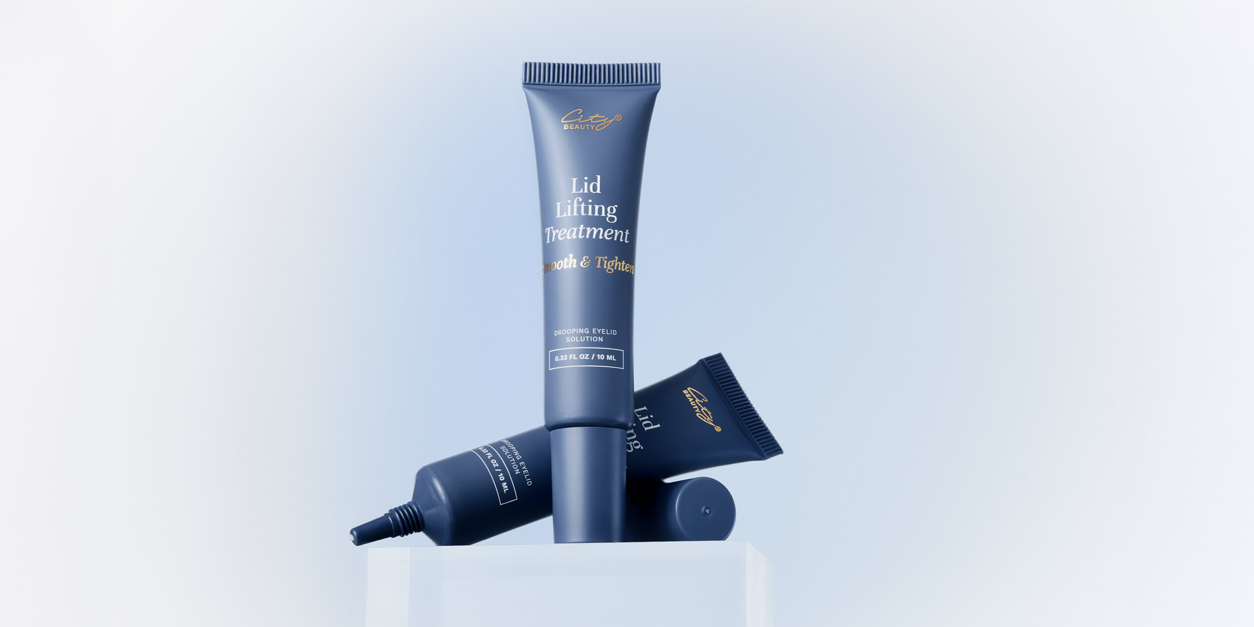 Two cosmetic tubes on a light background.
