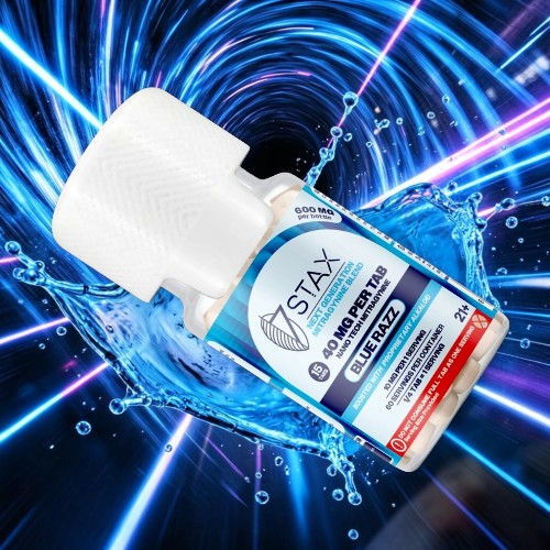 Bottle of STAX cleaner with dynamic blue background and water splash effect.