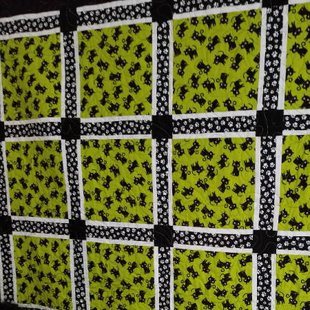 Picture of Cat Quilt using both regular 100% cotton fabric and quilter’s 100% cotton fabric