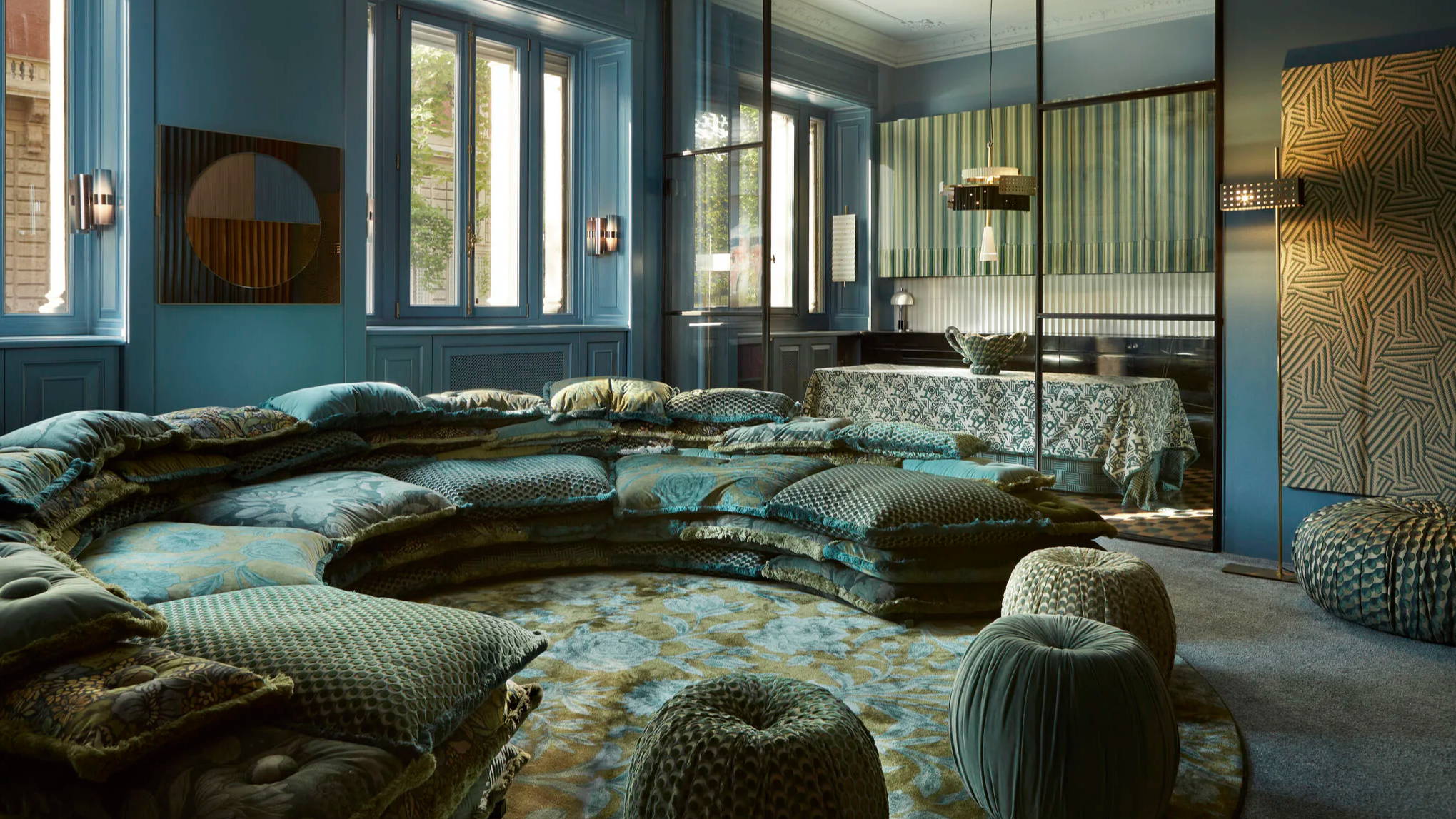 Cozy interior with blue walls, cushions, and natural light.