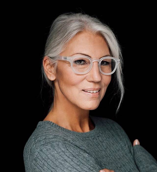 Woman with grey hair wearing clear glasses