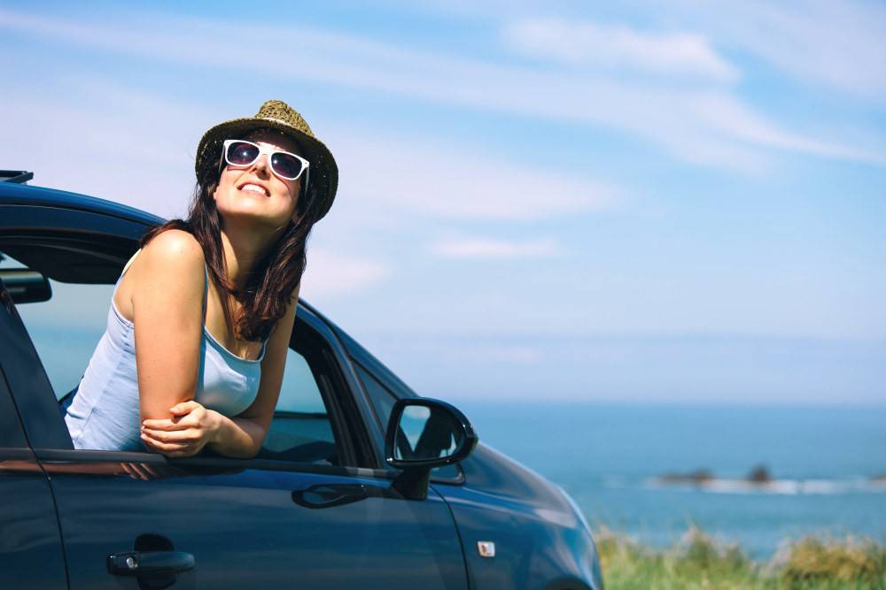 Relaxed happy woman on a roadtrip | Vegan Collagen Builder Vs Animal-Based Collagen Supplements: Which Is Best For You?