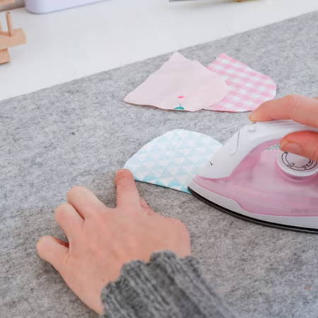 pressing quilting fabrics with a mini iron on a wool pressing mat