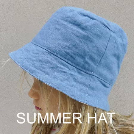 A blue brimmed hat for summer on a girl’s head